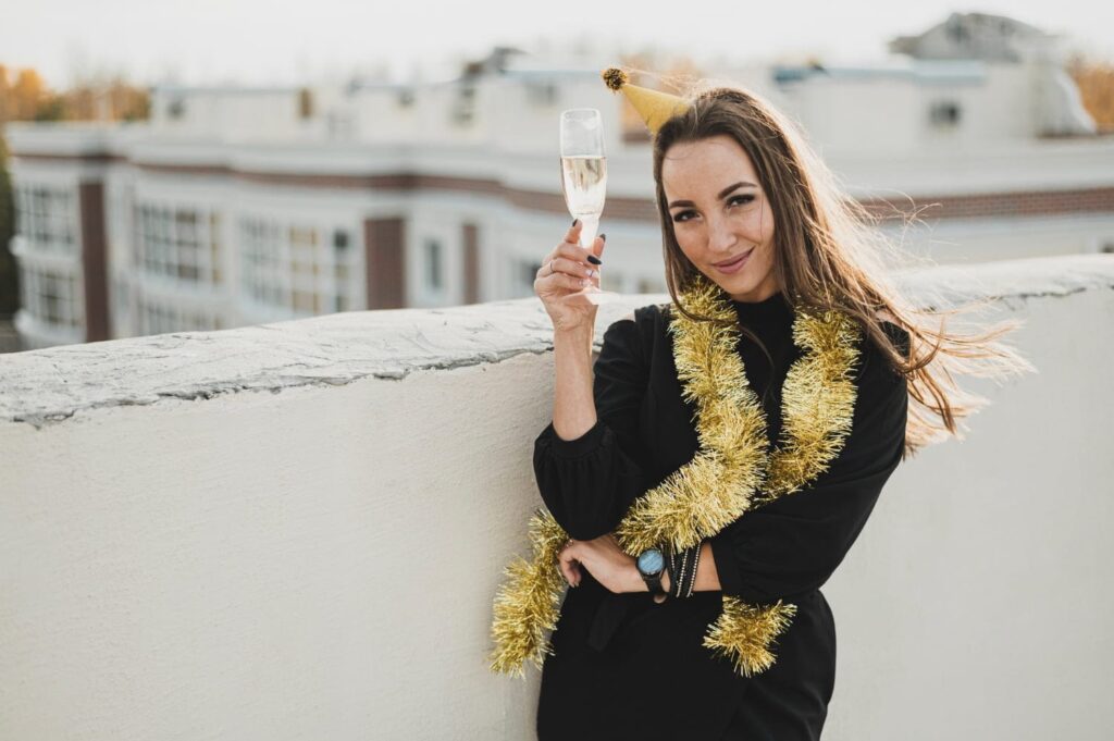 gorgeous woman black dress holding glass champagne